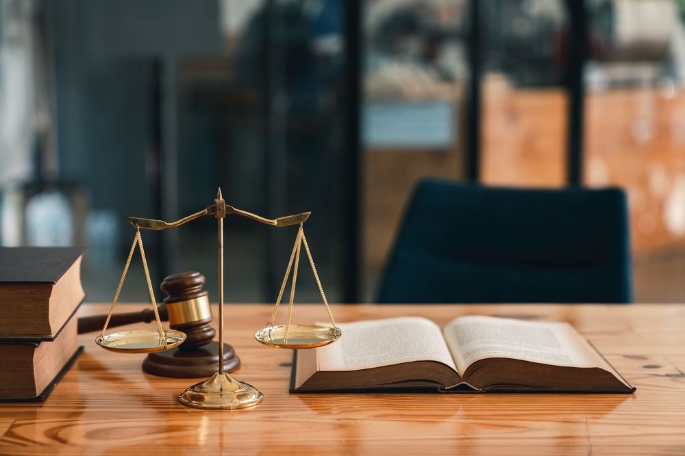 Desk with scales of justice and law book